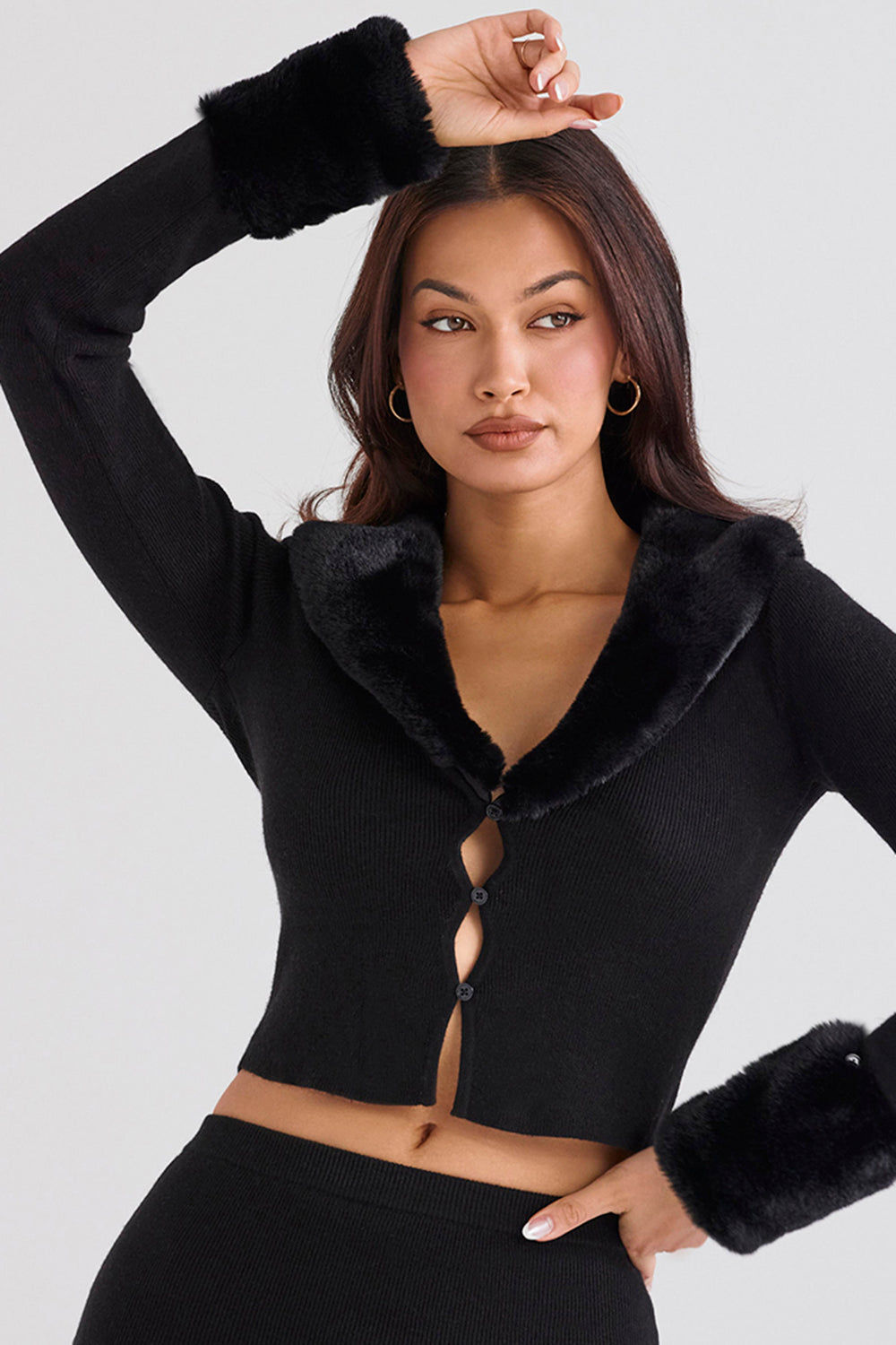 Black cardigan with faux fur trim and cashmere mini skirt